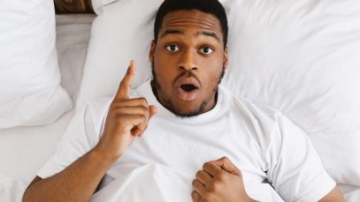African American Man Having Idea Lying In Bed At Home